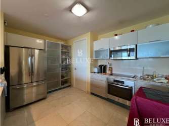 Contemporary apartment kitchen with island and stainless steel appliances at PH Casa Bonita Playa Bonita Panama