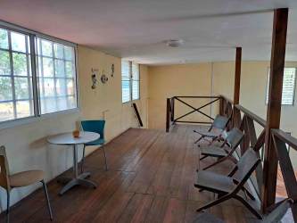 Retro bathroom with blue fixtures dolphin shower curtain in Playa Malibu Gorgona home