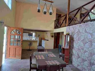 Cozy bedroom with arched window, striped bedspread, AC unit in Playa Malibu Panama