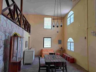 Rustic kitchen features tiled breakfast bar, exposed beams, and cozy space in beach home Gorgona Panama