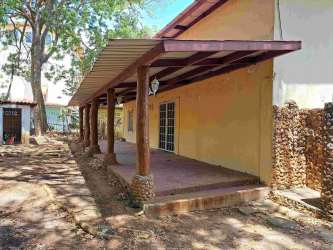 Mediterranean-style two-story beach house with terracotta roof, arched windows in Playa Malibu Gorgona