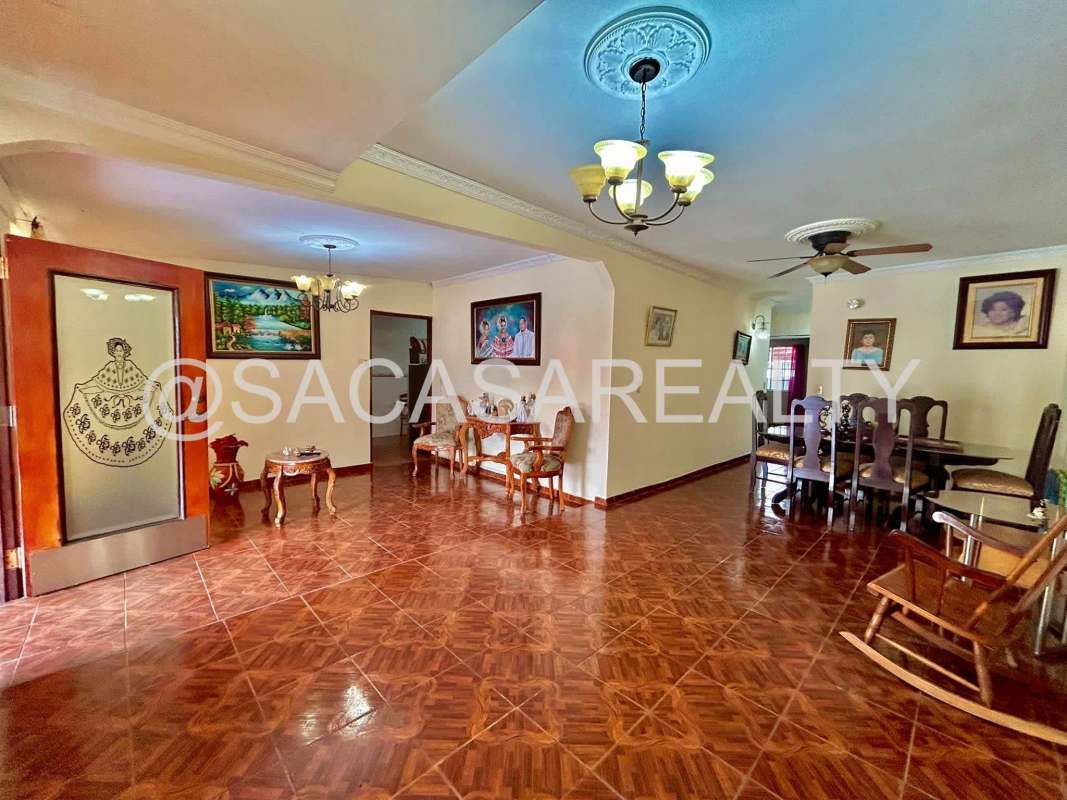 Tile floor dining room with chandelier in Las Cumbrecitas Panama home