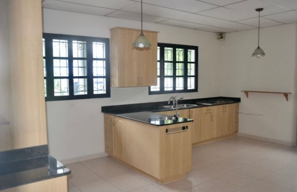 Spacious bright kitchen, wood cabinets, granite countertop in Villa Bella Panama home