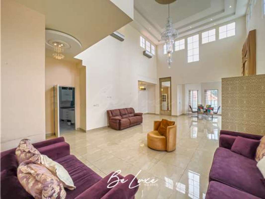 Bright formal living room with double height ceilings, tile floors in Altos del Golf Panama