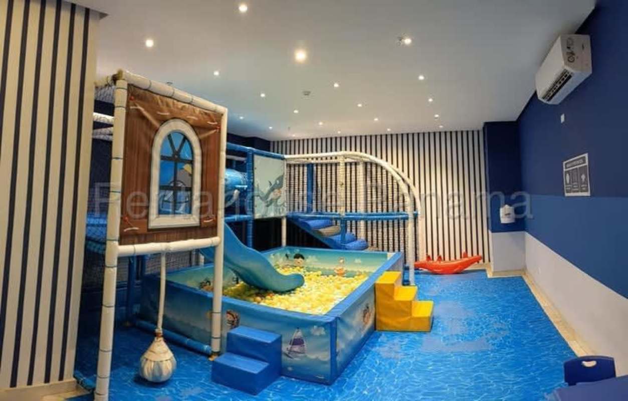 Colorful indoor children's playground facility with slide and ball pit in Park City Tower Obarrio