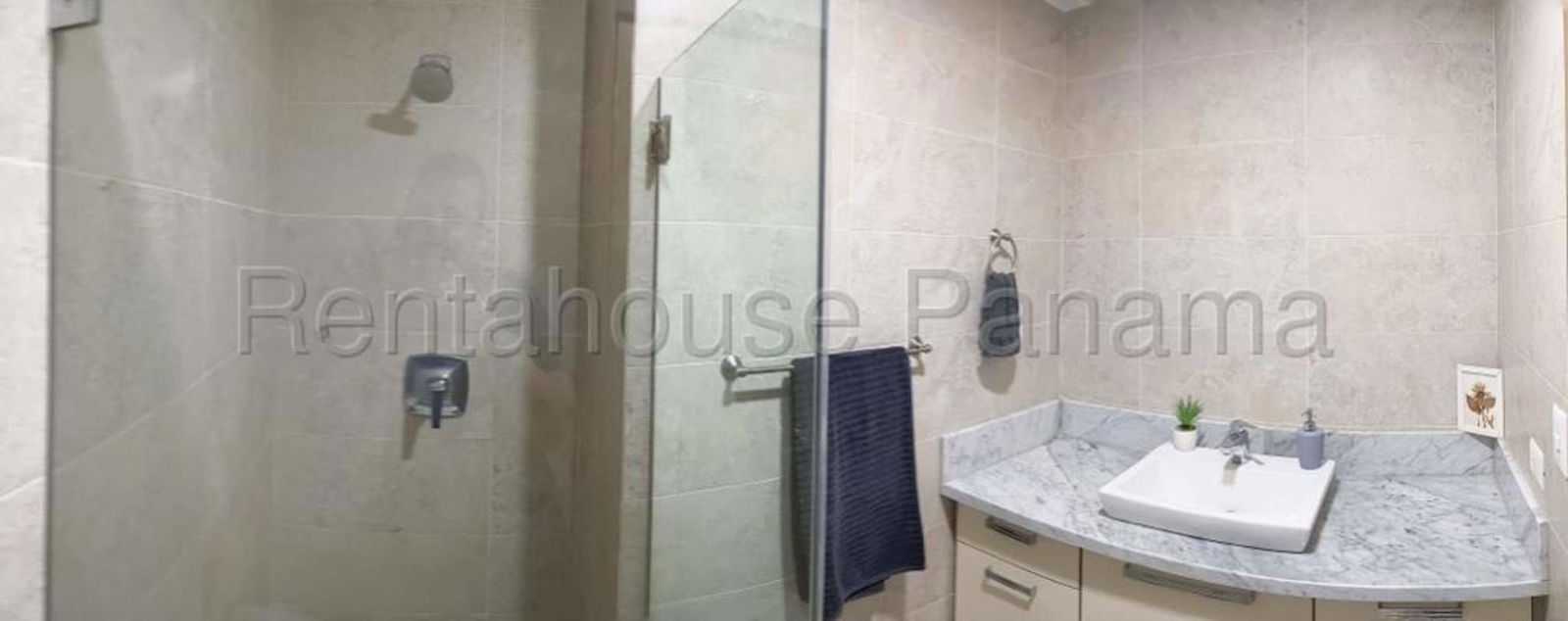 Bathroom with beige designer tiles and glass shower enclosure PH Park City Obarrio Panama
