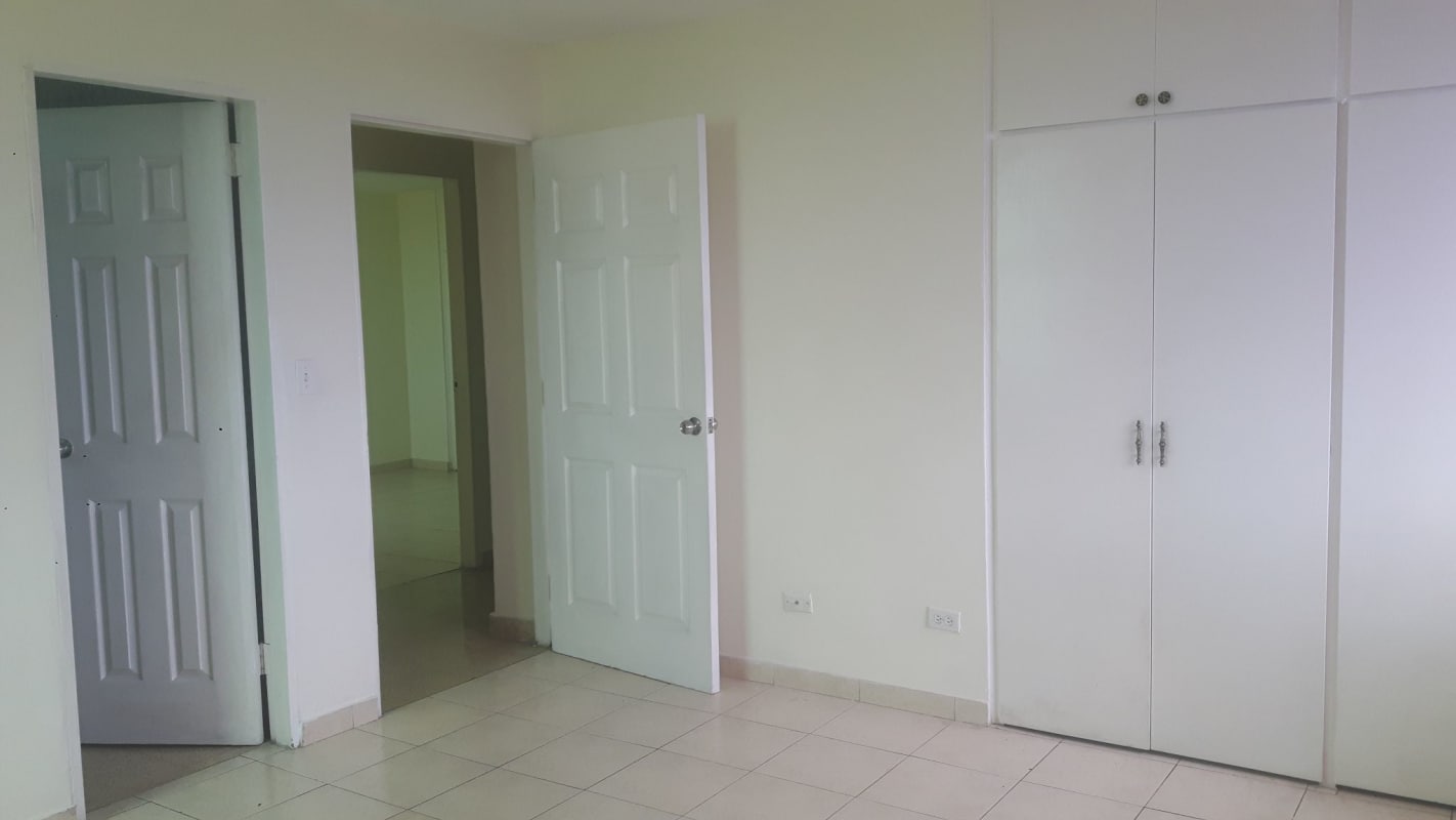 Empty bedroom with closet, cream walls and tiled floor in Panama City El Dorado apartment