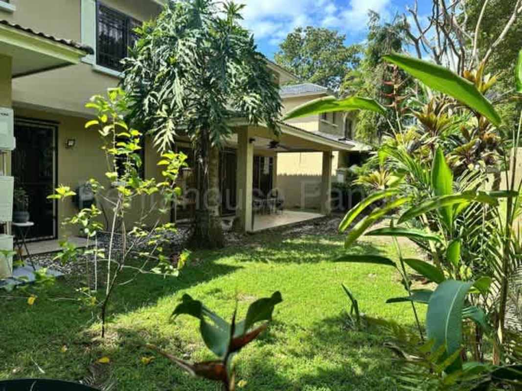Covered outdoor terrace with ceiling fan and tropical garden view house in Clayton Panama