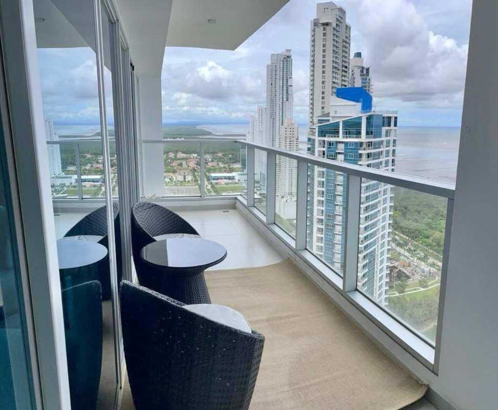 Modern dining space with ocean view and balcony access at PH Parkside Costa del Este Panama City