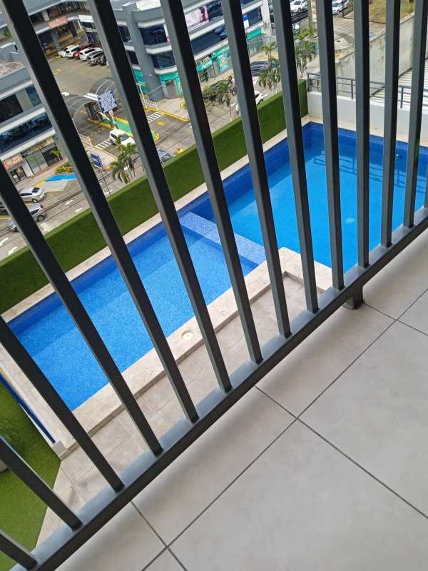 Balcony scene overlooking pool and commercial area in PH Alai Panama