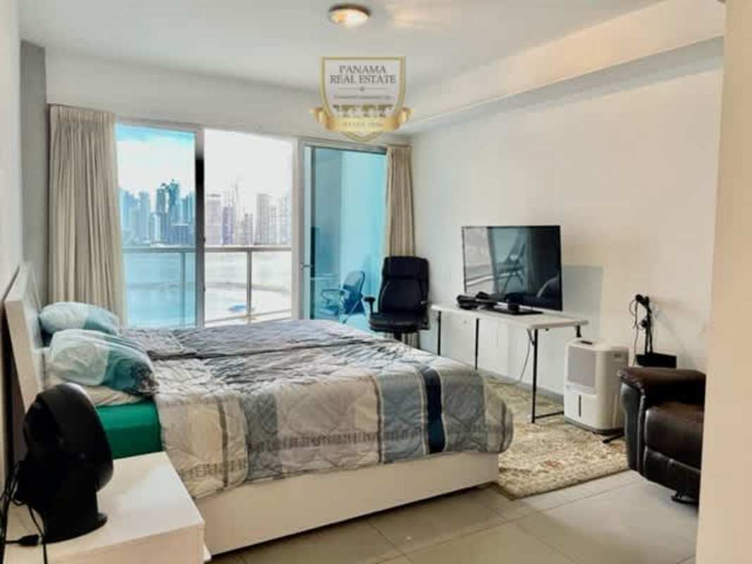 Bedroom with access to private balcony and panoramic Pacific Ocean views in PH Yacht Club Panama City