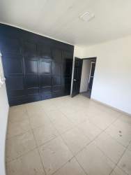 Bright bedroom with large windows and built-in closet in family home for rent