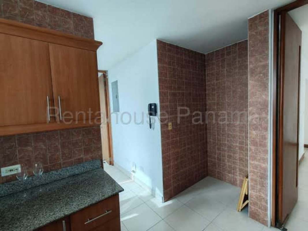 Bright living room leading to balcony with city skyline view in Panama