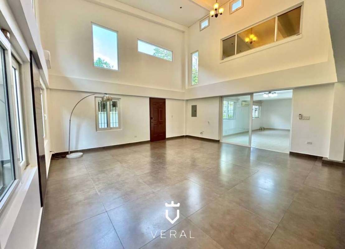 Spacious backyard with mature trees and large grassy area in Cardenas Village Clayton Panama