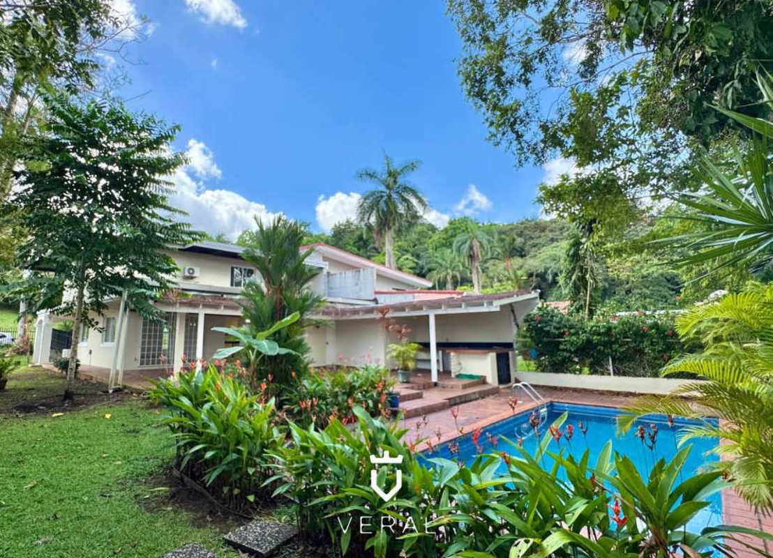 Private swimming pool surrounded by garden and covered terrace in Cardenas Village Panama