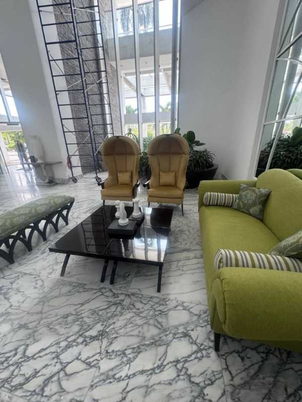 Modern condominium tower exterior with landscaped entrance and palm trees PH Rivage Panama