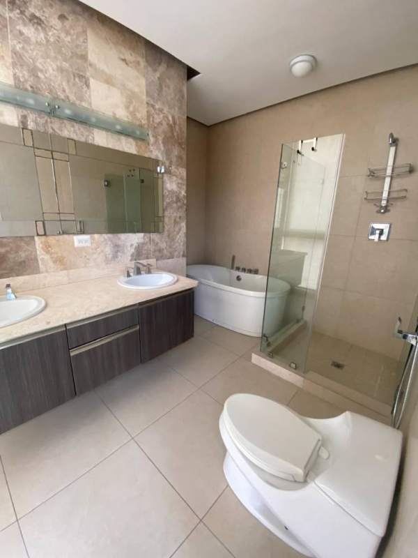 Modern bathroom with double sink vanity, glass shower and marble countertop at PH Rivage Panama