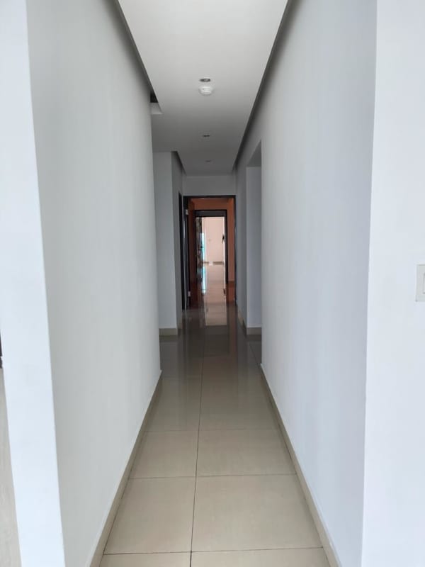 Bright hallway with porcelain tile floors leading through apartment in PH The View Panama City