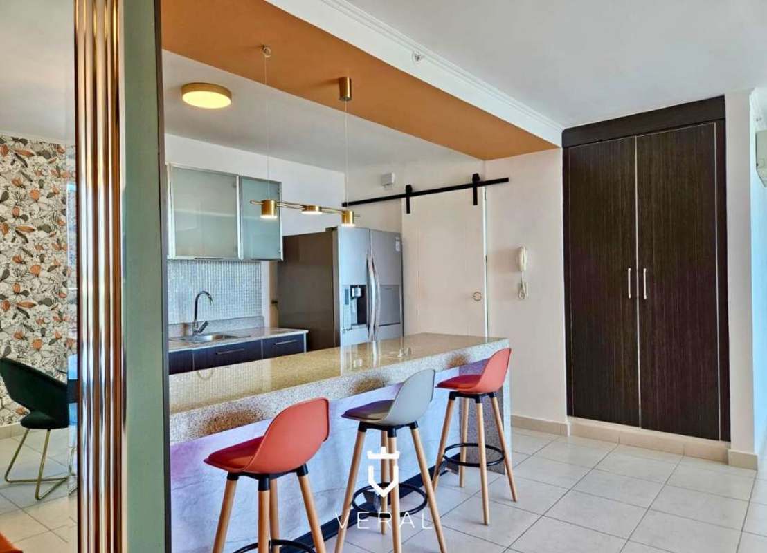 Modern kitchen with granite bar, mosaic backsplash, appliances and stools PH Miró El Cangrejo Panama