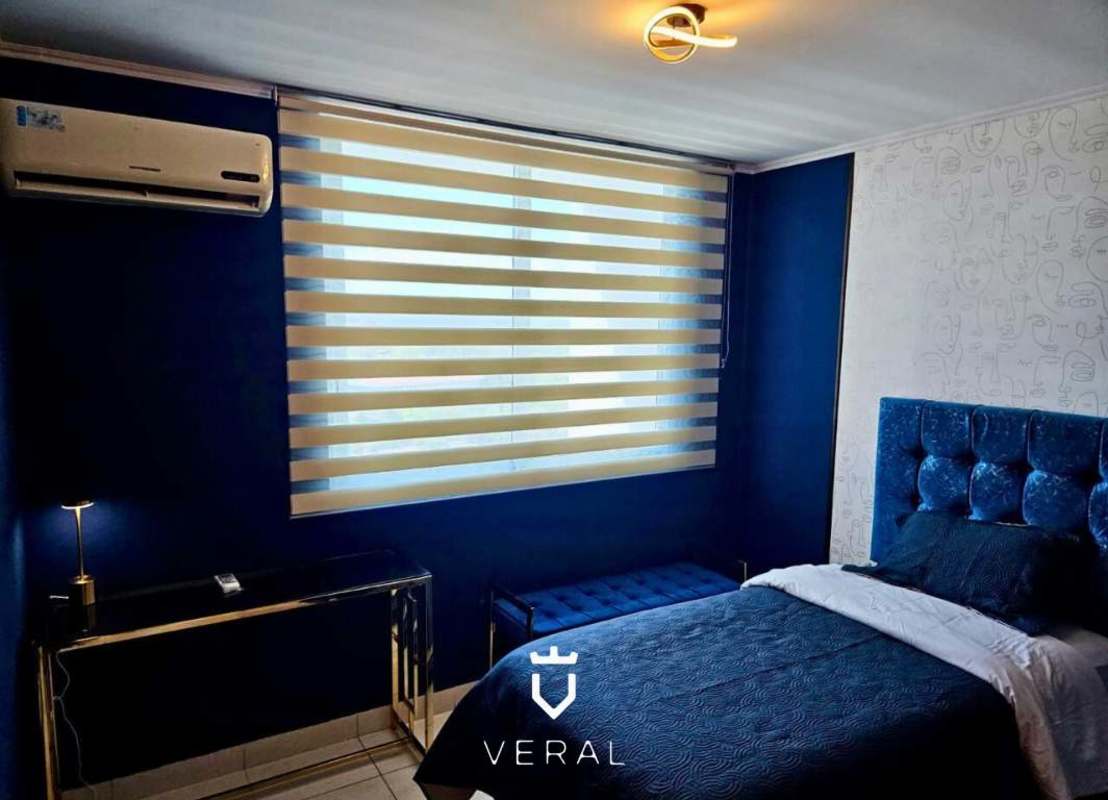 Bright bedroom with built-in closet AC and modern decor at PH Miró Panama