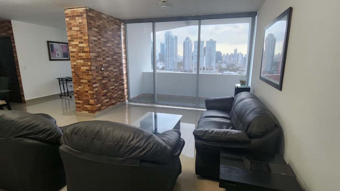 Modern furnished apartment living room with large windows and city skyline views in PH San Francisco Bay Panama City