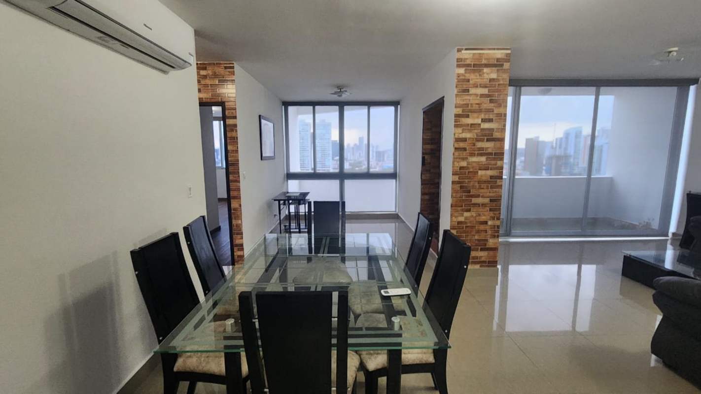 Master bedroom with large window offering skyline views furnished PH San Francisco Bay Panama City