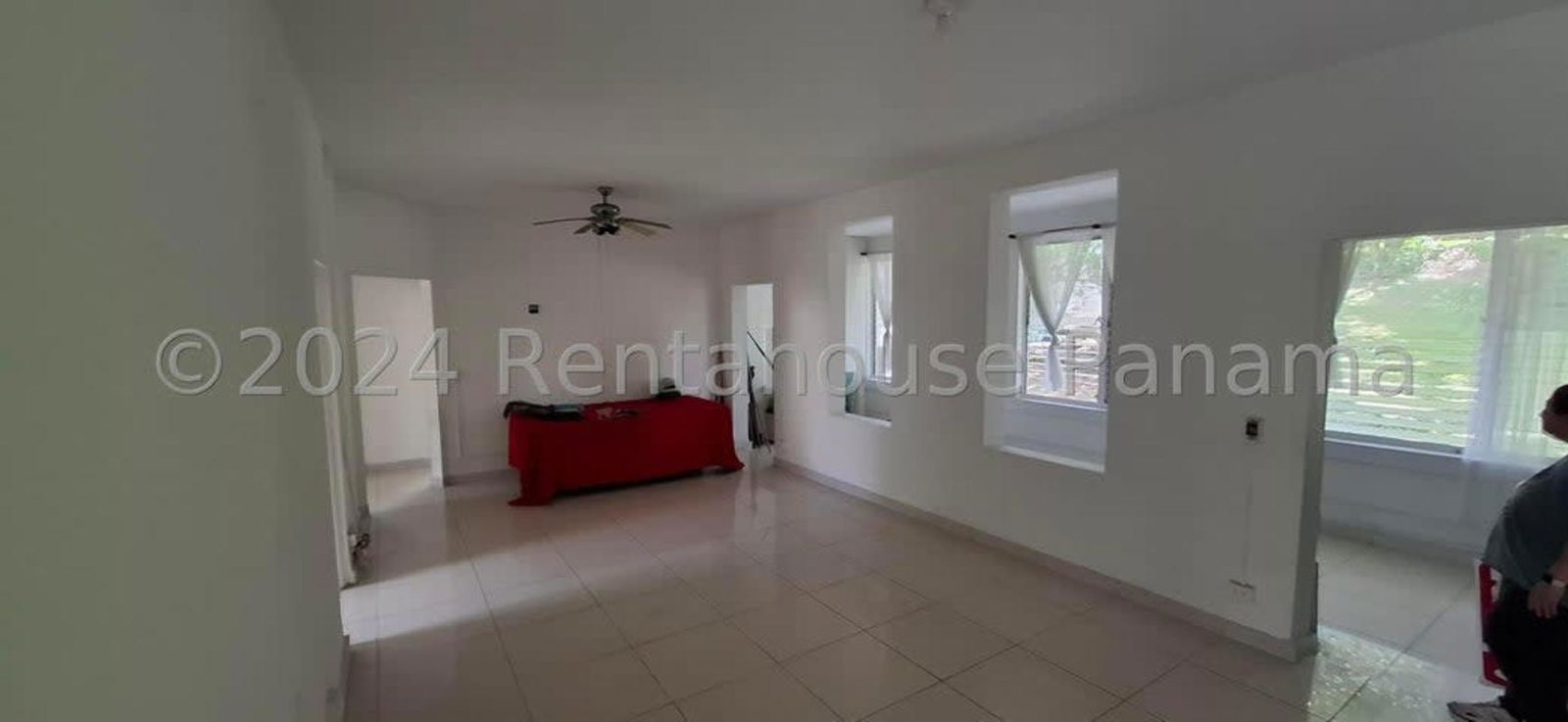 Simple white kitchen with double sink and natural light window in Balboa Ancon apartment Panama City