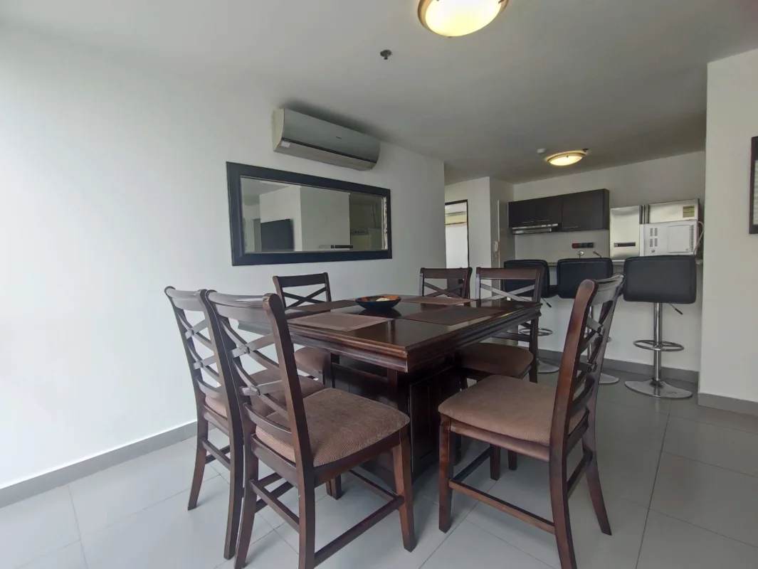 Dining space with table chairs next to equipped kitchen Bella Vista Tower Panama