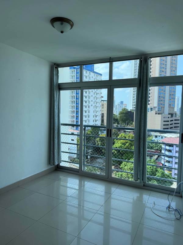 Living room with floor-to-ceiling windows overlooking city PH Teus Tower Panama City