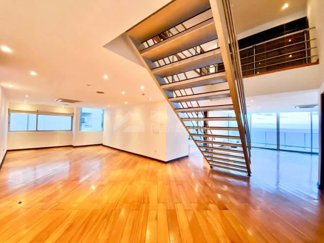 Elegant living room with floor-to-ceiling windows and ocean views at PH Ocean Two