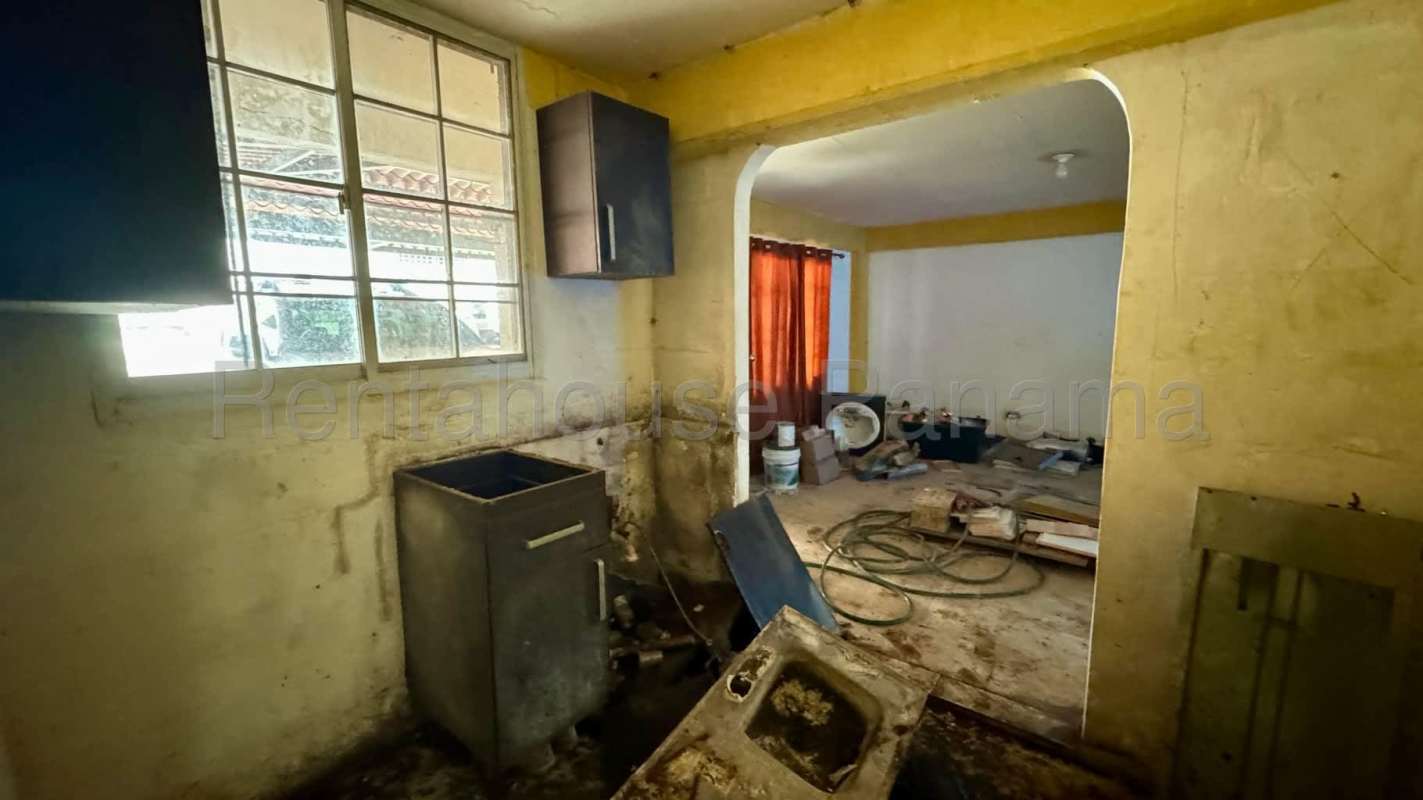 Basic kitchen area needing renovation with tile backsplash, window in Albrook Clayton Panama