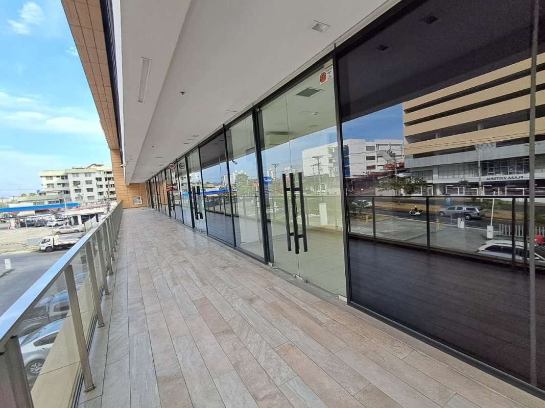 Modern commercial plaza exterior with glass storefronts and walkway at Liberty Plaza Panama City
