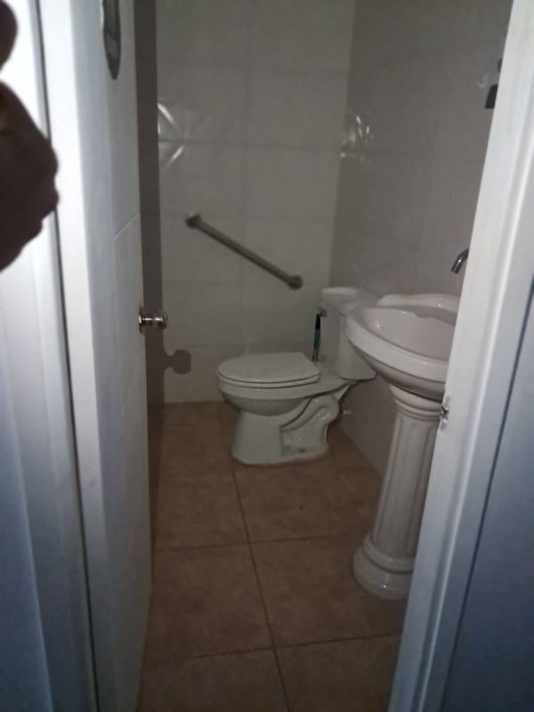 Simple restroom with pedestal sink and toilet in retail office unit Liberty Plaza Panama