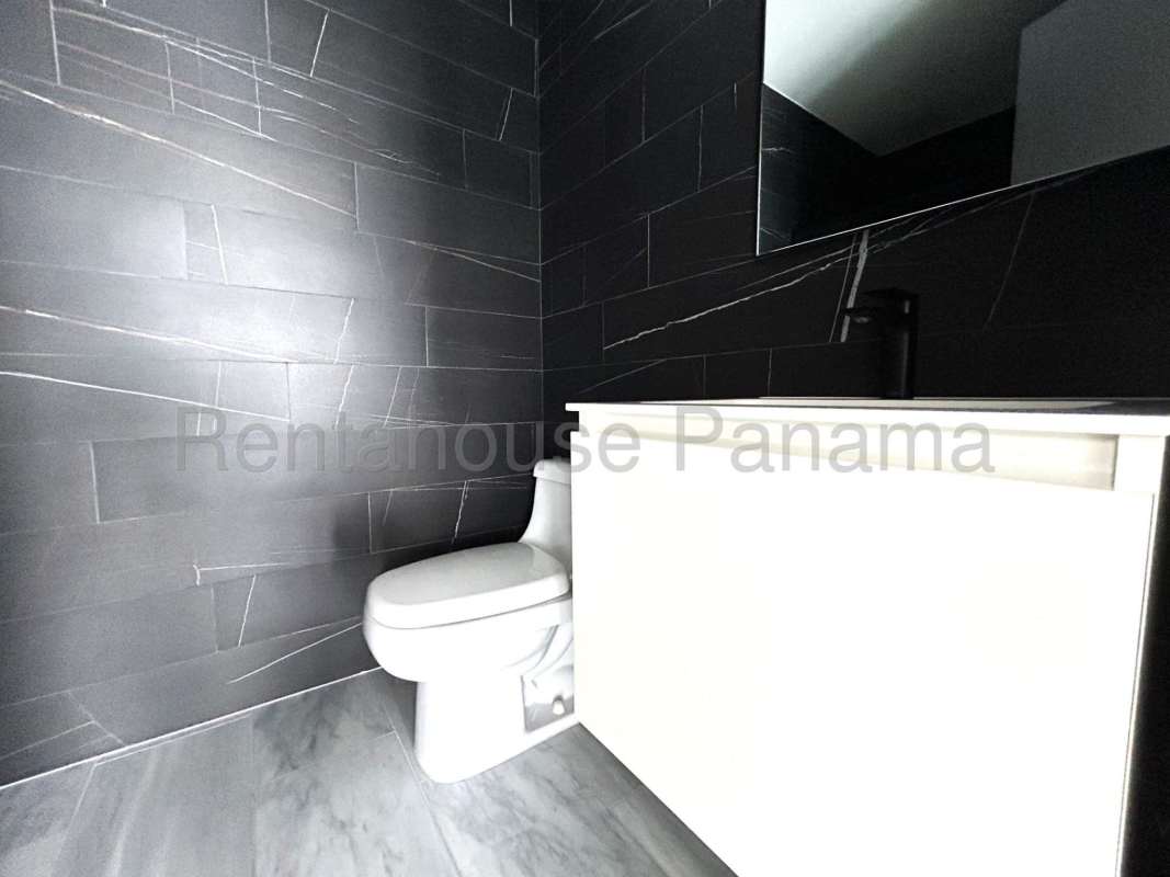 Luxury bathroom with marble walls and large mirror in Nuovo by Armani Casa Panama City