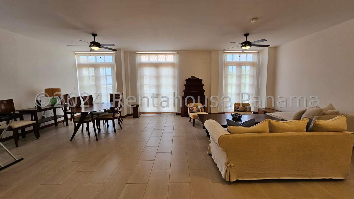 Spacious living and dining room with high ceilings and large windows at Star & Herald Casco Viejo Panama