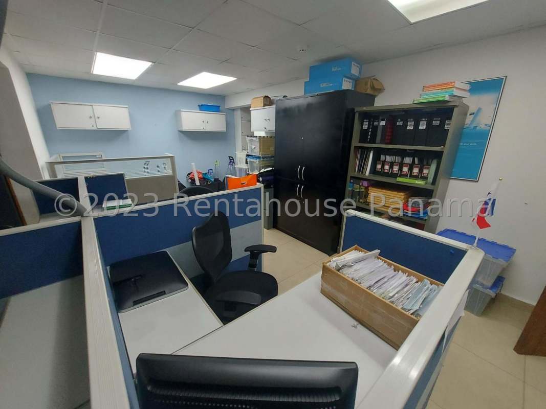 Partitioned interior office with storage shelves, tile floor in commercial building Parque Lefevre Panama