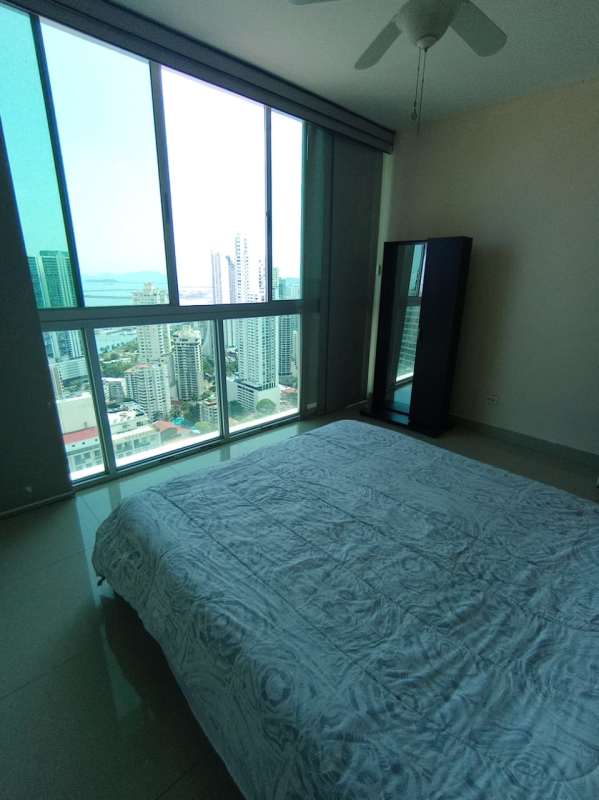 Bright bedroom with window and ocean-city views in PH Marina Plaza Panama City