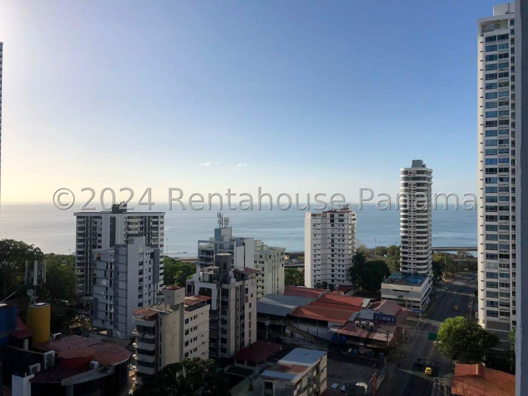 Spacious living room with large windows and contemporary furnishings in Coco del Mar apartment
