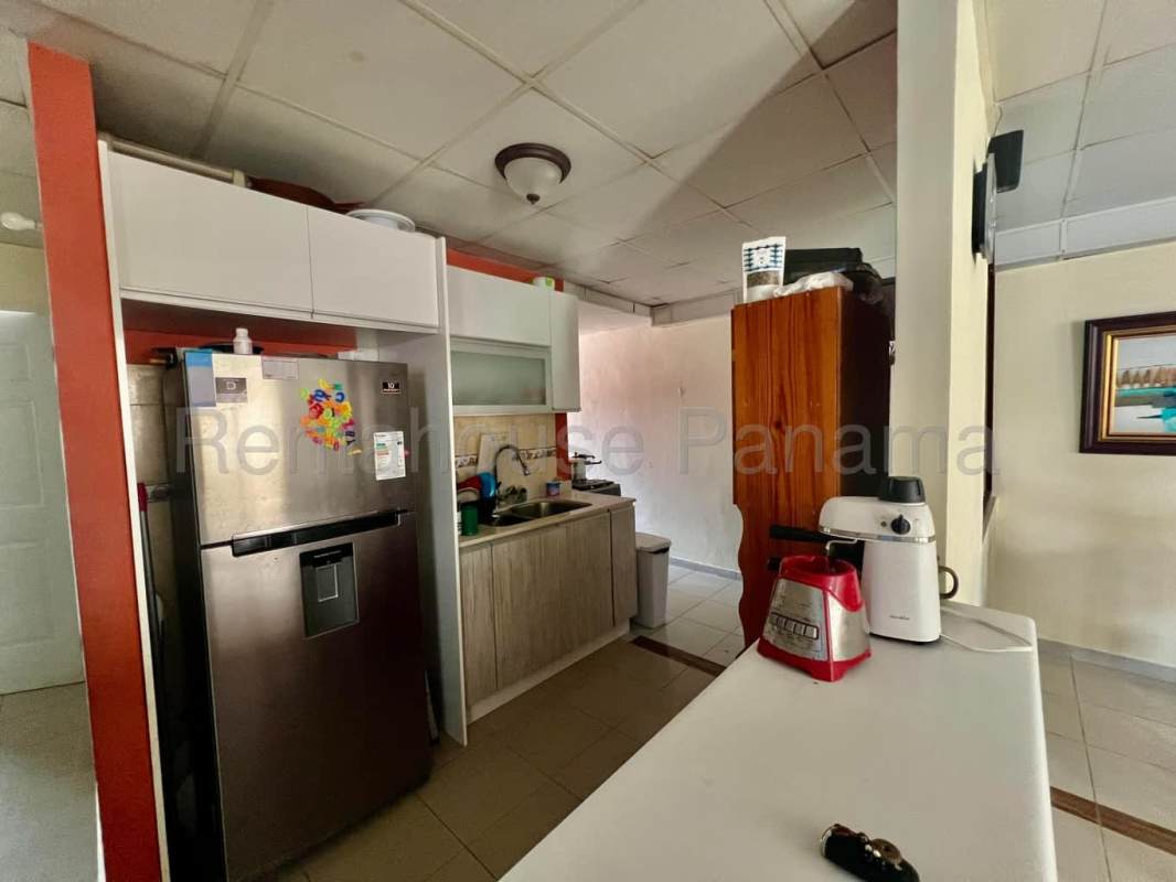 Bathroom with shower glass enclosure, pendant sink, beige walls in Panama house