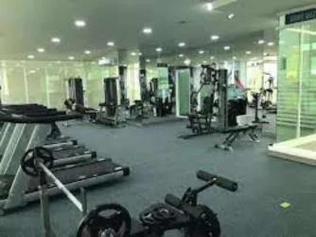 Modern gym with cardio, weight machines and mirrors at PH Metropolitan Park Panama City