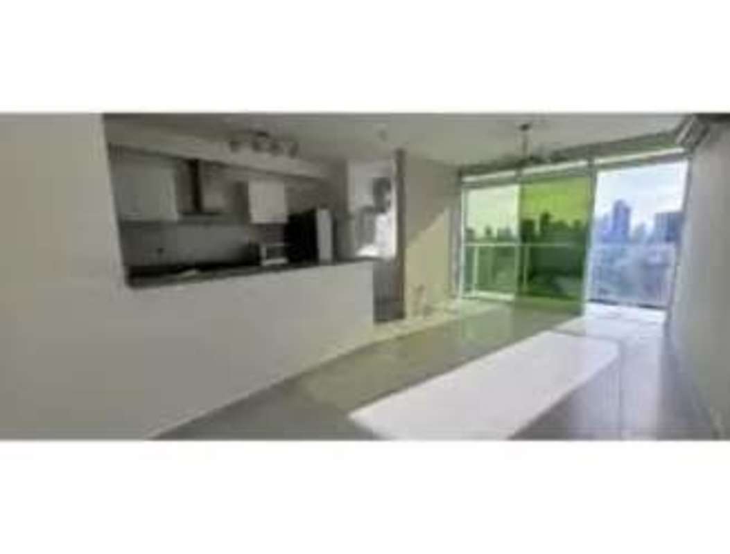 Open-plan living room with glass doors to balcony city view in PH Metropolitan Park Panama
