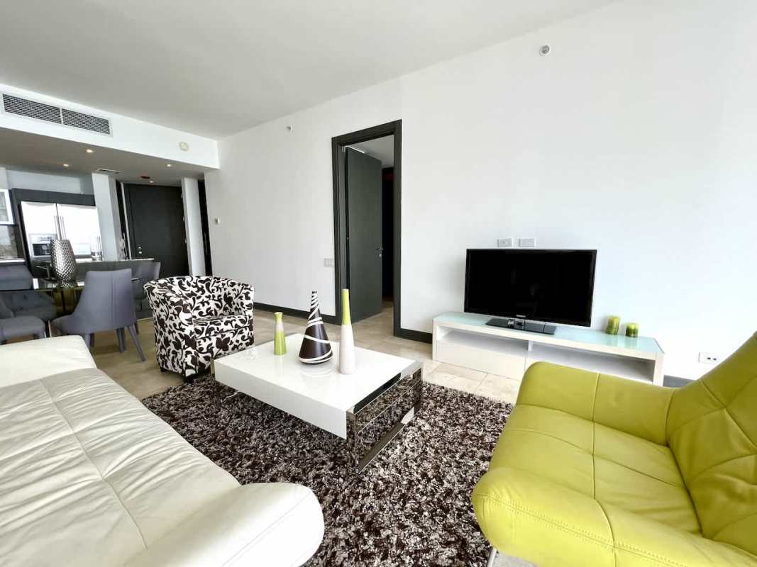 Contemporary kitchen with granite countertops and stainless appliances in Punta Pacifica apartment