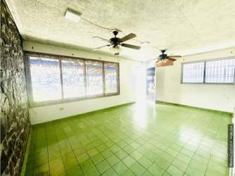 Spacious bright living or showroom with green tile floor, large windows, ceiling fans in commercial duplex David Chiriquí