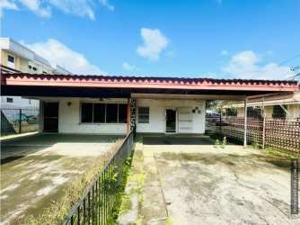 Gated covered parking area with metal roof and driveway at commercial duplex David Chiriquí