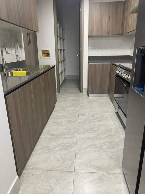 Modern galley kitchen with granite counters and appliances in PH Cranc Tower, El Cangrejo Panama