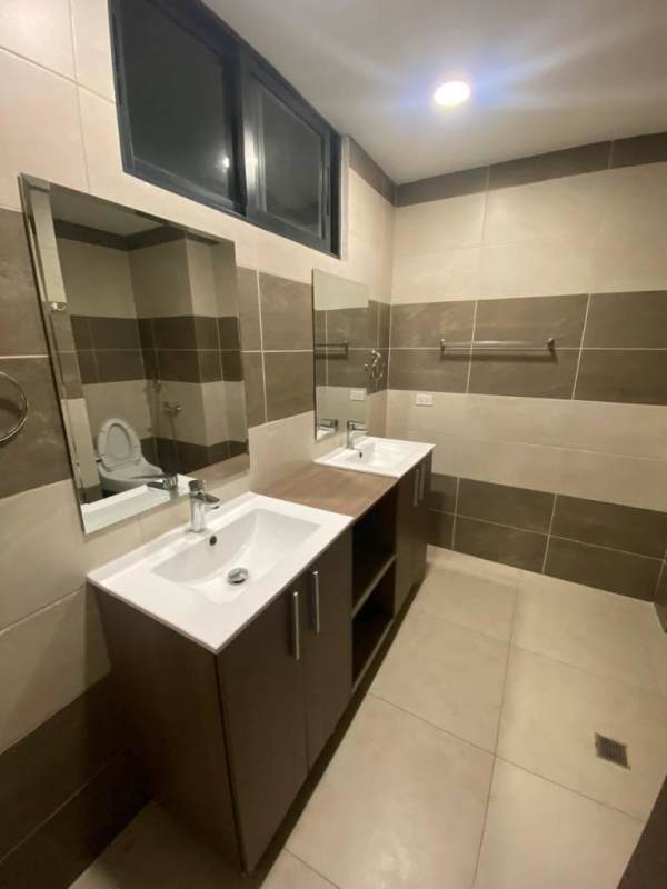 Modern bathroom with tiled shower and granite vanity at PH Cranc Tower El Cangrejo Panama