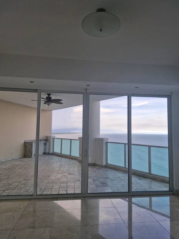 Elegant ocean view bedroom with large windows and walk-in closet in Trump Tower Punta Pacifica