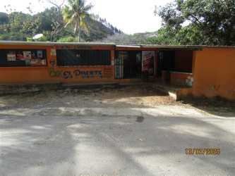 Orange facaded storefront with vending machines, graffiti rural Santa Fe Panama
