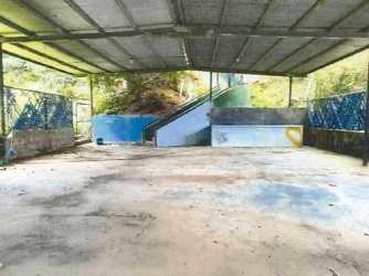 Open-sided outdoor structure with concrete flooring and colorful mural in Santa Fe rural area Veraguas
