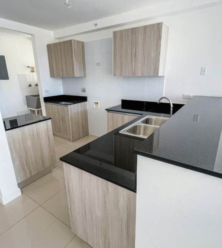 Open plan kitchen with cabinets and breakfast bar PH Coral Plaza